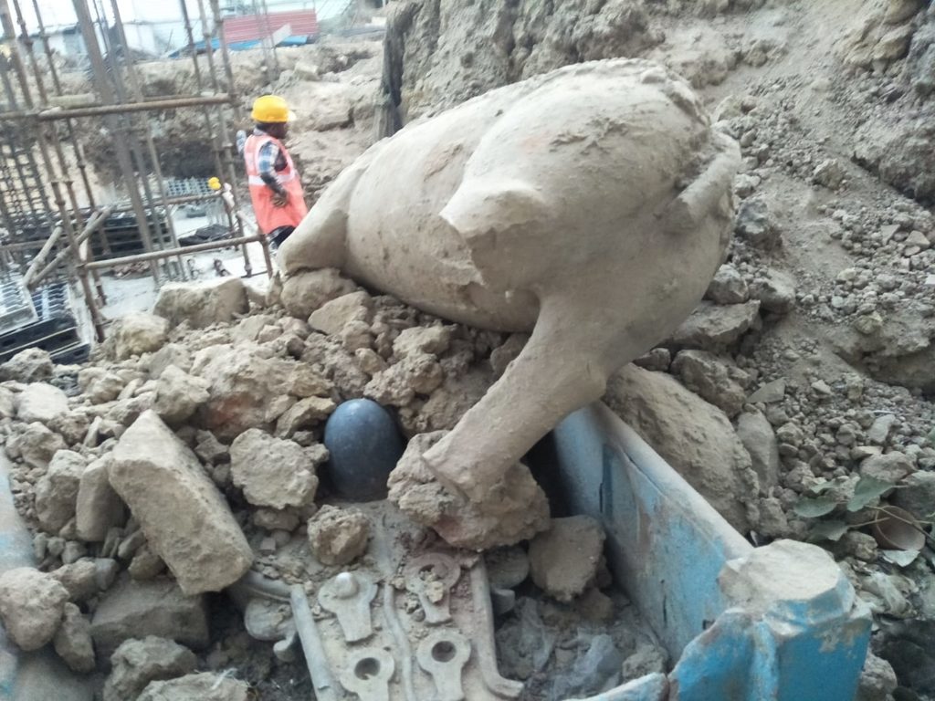 A broken Nandi statue inside rubble on the Ghats of Varanasi 