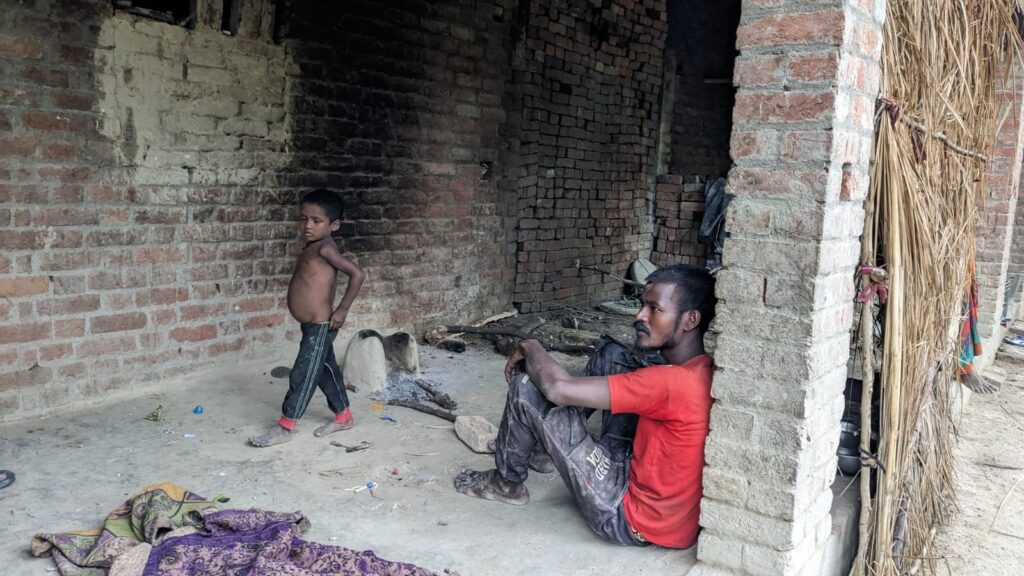 Punnavasi at his home in Arvansi village of Phoolpur, Prayagraj with the corpse of his three years daughter 