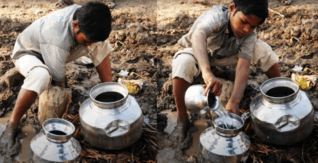 A boy digging soil for water