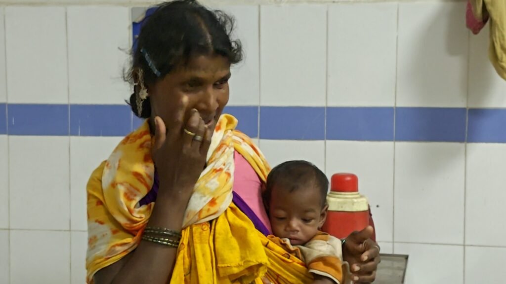A tribal woman with her adolescent in government hospital, Balaghat